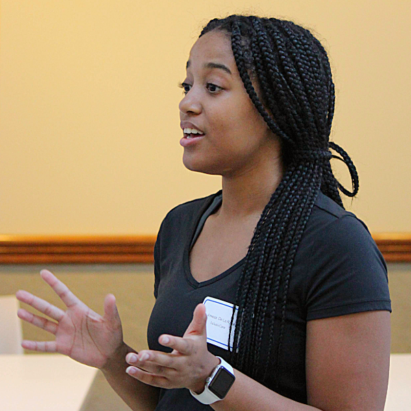 A student answers questions about her poster at Galvin Scholars Poster Session 2023