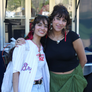 Two female students posing in front of the food truck at Galvin Scholars Year-End Event