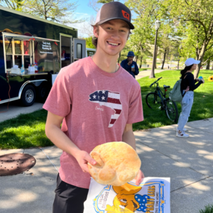 A student holds an elephant ear at Galvin Scholars Year-End Event