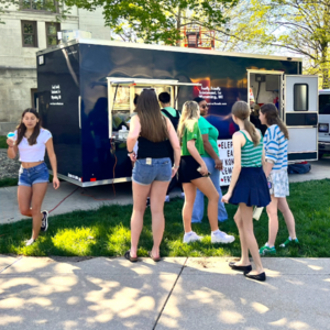 Students line up in front of food truck at Galvin Scholars Year-End Event