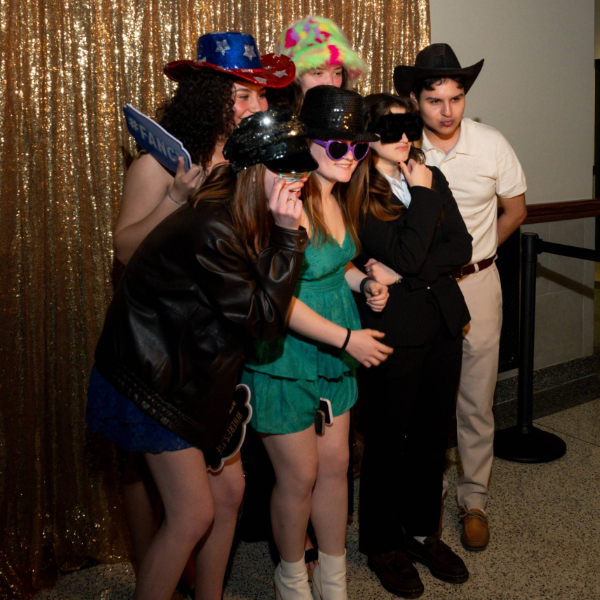 Several students posing with funny outfits for photo booth at Galvin Scholars Gormal