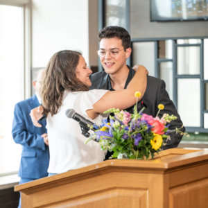 2024 Galvin Scholar Student Brunch professor Young hugging Alan Avalos